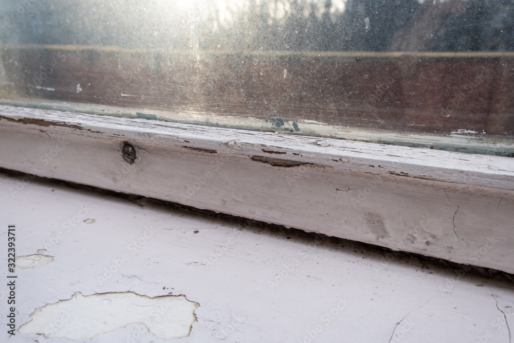 Old wooden window with peeling paint and durt needed to be repaired or replaced Old wooden window with peeling paint and durt needed to be repaired or replaced