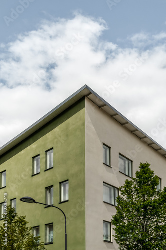 Corner of a green building and trees