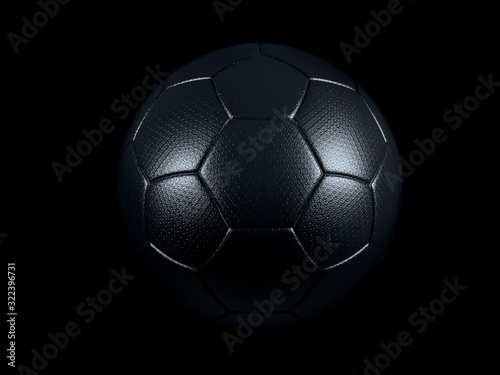 Black football or soccer ball against black background. © Martin Piechotta