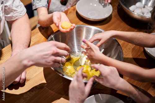 Separate the egg into protein and yolk. Funny master class for children on baking pizza and italian ice cream. Young children learn to cook. Kids preparing homemade pizza. Little cook.