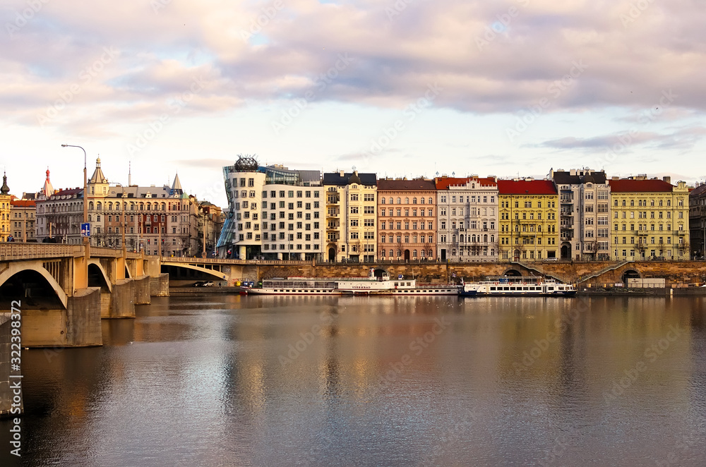 Vltava river in Prague with dancing house and ancient buildings. World water day.