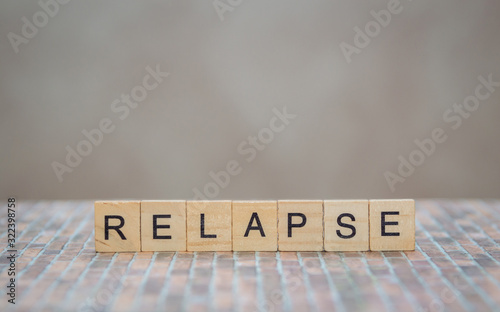 the word relapse, made of wooden cubes