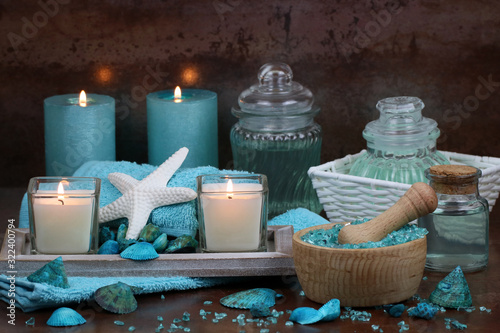 Spa composition with towels and candles in turquoise