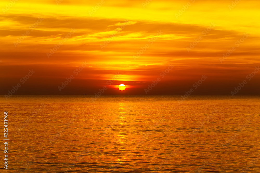 sunset with large yellow sun under the sea surface