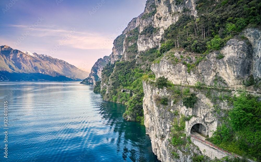 Beautiful landscape. View of Lake Garda and the Ponale trail carved into the rock of the mountain , Riva del Garda,Italy. Popular destinations for travel in Europe