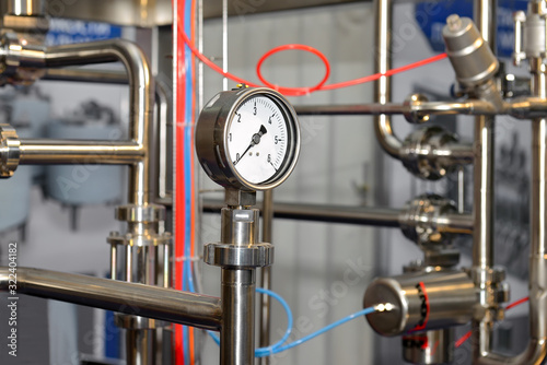 Pressure gauge on milk pipeline in production of dairy products