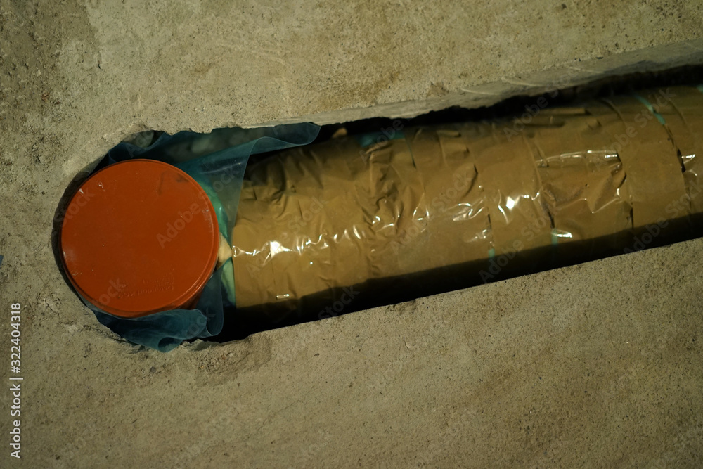 Installation of isolated PVC pipes under the floor. Stock Photo Adobe