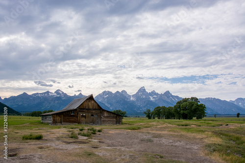 old mormon barn farm andy chambers residence in summer with blue colored grand tetons in background
