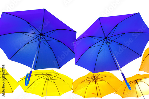 Blue and yellow umbrellas on a white isolated background