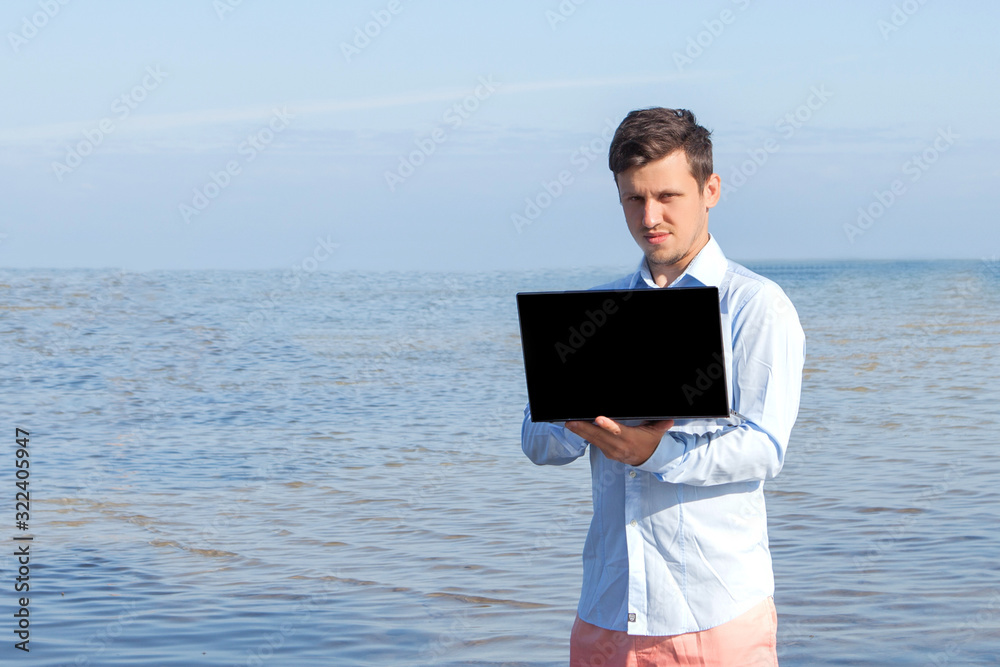Male businessman with a laptop in the water. Freelance work concept
