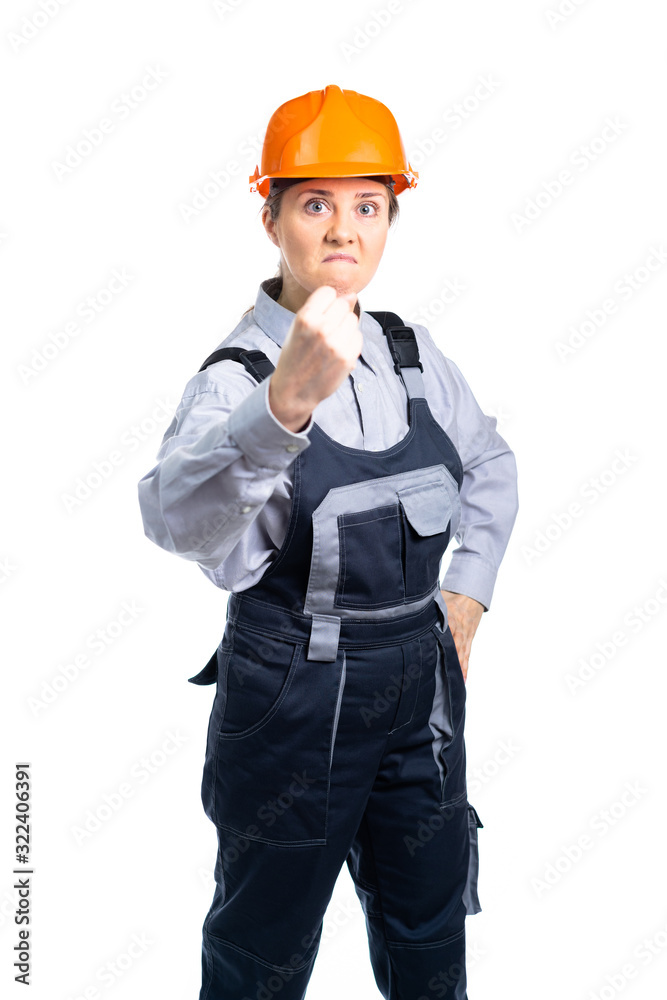 menacing girl builder shows his fist to the camera is very unhappy with the result. Isolated