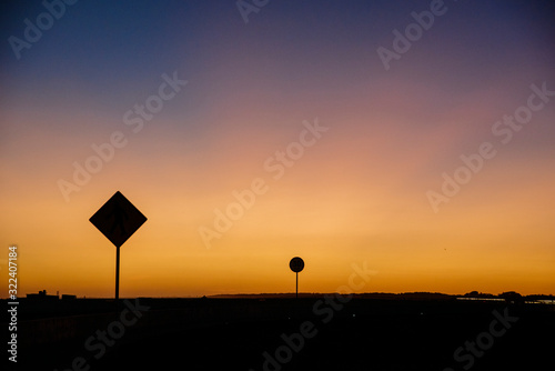 colorful sunset with traffic signs