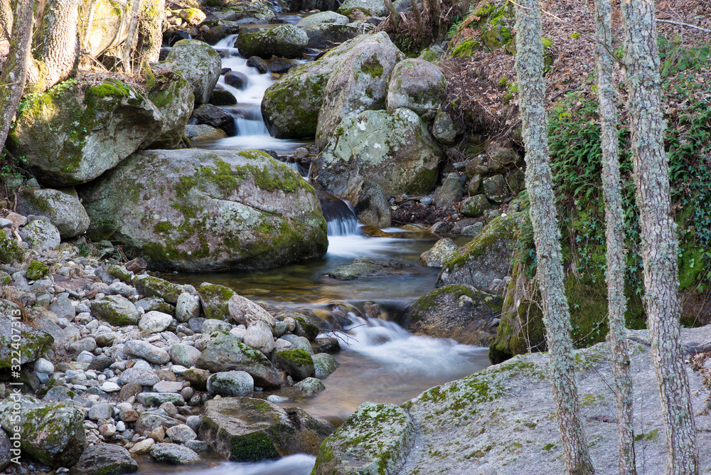 background of crystal clear water running between the stones