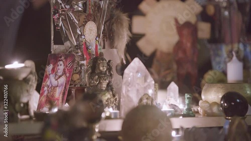 Close up of Feng Shui altar at home in living room on the table. Art. Attracting wealth and prosperity concept, rystal clusters, golden Buddah figure and candles. photo