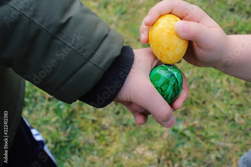 Zwei Ostereier lassen sich von zwei Kindern aufeinander treffen 