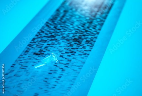 Close-up of DNA sample lying on DNA sequencing result chart photo