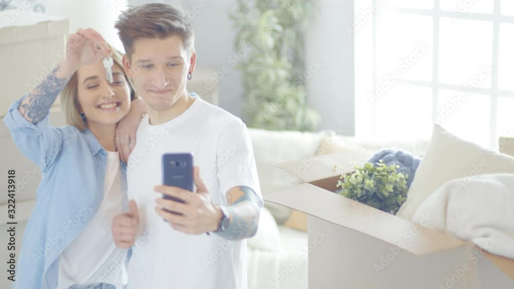 Happy young Caucasian couple making selfie with keys from new flat. Happy young Caucasian couple making selfie with keys from new flat.