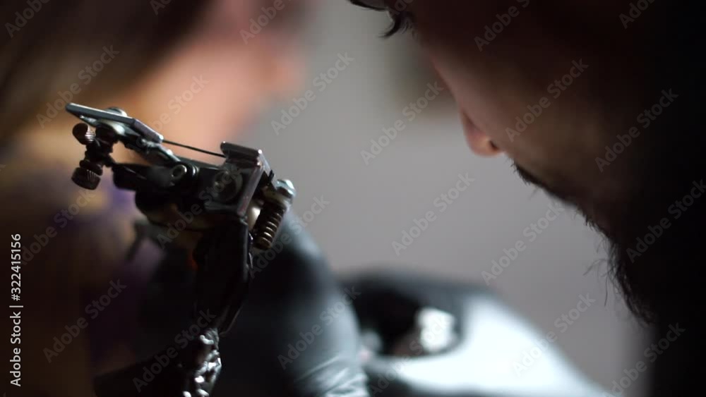 Portrait of man tattoo, creation tattoo on female body under the lamp light. Slow motion. Professional artist Portrait of man tattoo, creation tattoo on female body under the lamp light. Slow motion. Professional artist