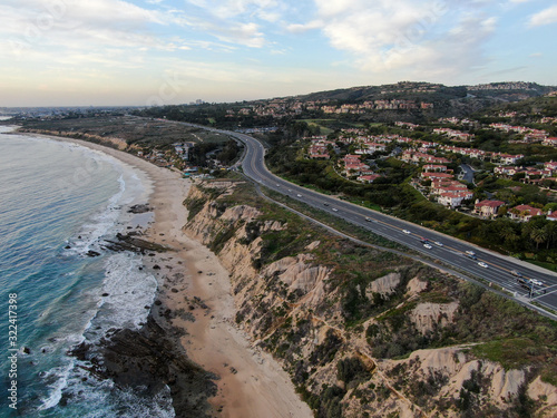 Aerial view of Newport Beach small road next to the cliff during sunset twilight in southern California, USA