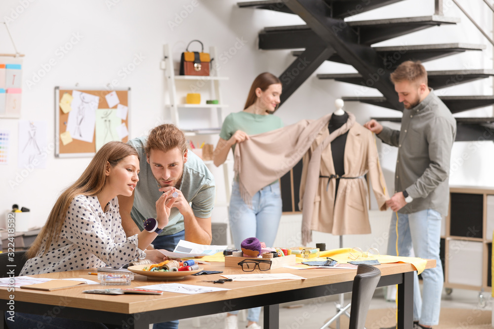 Fashion designers creating new clothes in studio