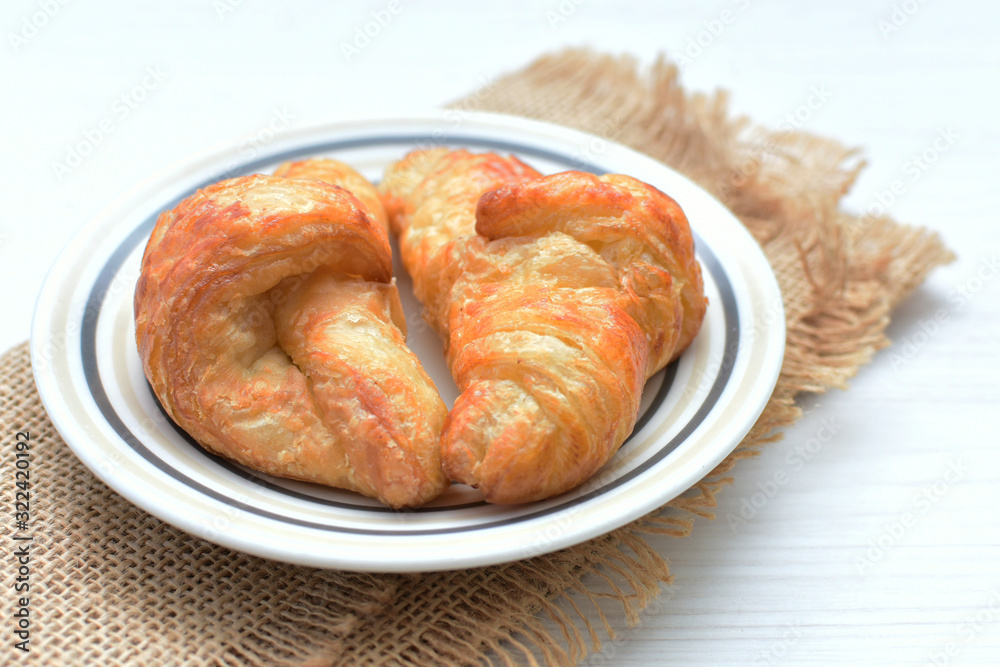 Small butter croissant, accompanied by blackberry jam Small butter croissant, accompanied by blackberry jam