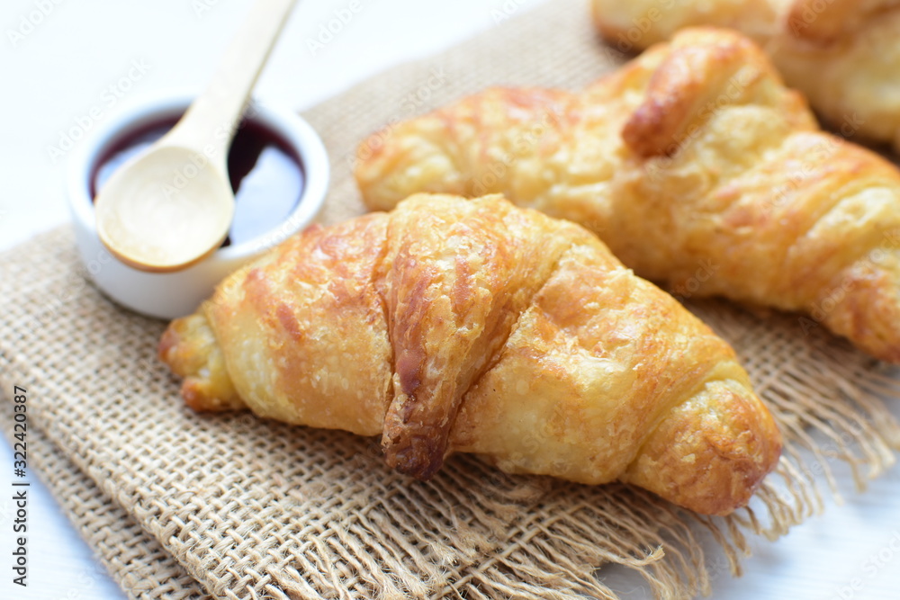 Small butter croissant, accompanied by blackberry jam Small butter croissant, accompanied by blackberry jam