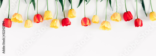 Beautiful composition of spring flowers. Yellow and red tulips flowers on white background. Valentine's Day, Easter, 8th march, Mother's Day. Flat lay, top view, copy space, banner #322421794