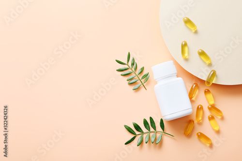 Fish oil vitamin capsules on light color background photo