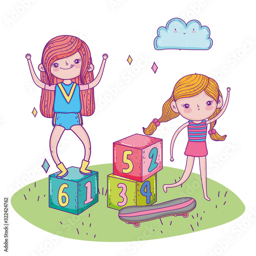 happy childrens day, girls playing with blocks and skateboard grass