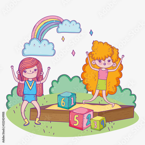 happy childrens day, girls playing in sandbox with blocks park