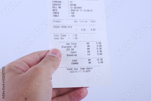 Kuala Lumpur, Malaysia - January 5, 2020 - A hand hold Purchase receipt with 6 percent of Sale and Services Tax. 