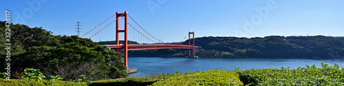 青空に映える赤い平戸大橋と紺碧の海のコラボ情景＠長崎