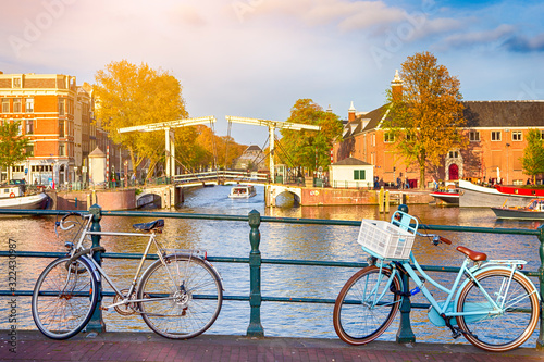 Traditional Dutch Bicycles In Amsterdam Against Bridge in the Background photo