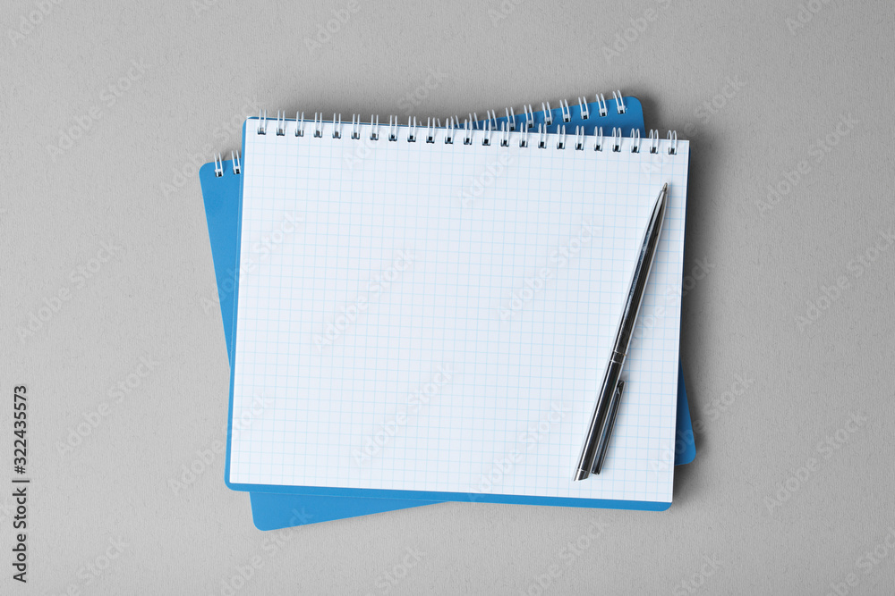 open notebook with pen on a gray background open notebook with pen on a gray background