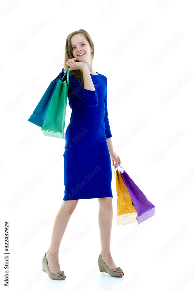 Teenager girl shopping in a store with large paper bags. Teenager girl shopping in a store with large paper bags.