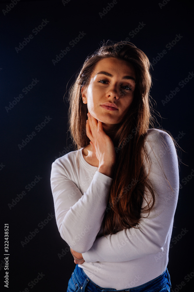 Portrait of an attractive girl holing her hair, while looking handsome and satisfied. Portrait of an attractive girl holing her hair, while looking handsome and satisfied.