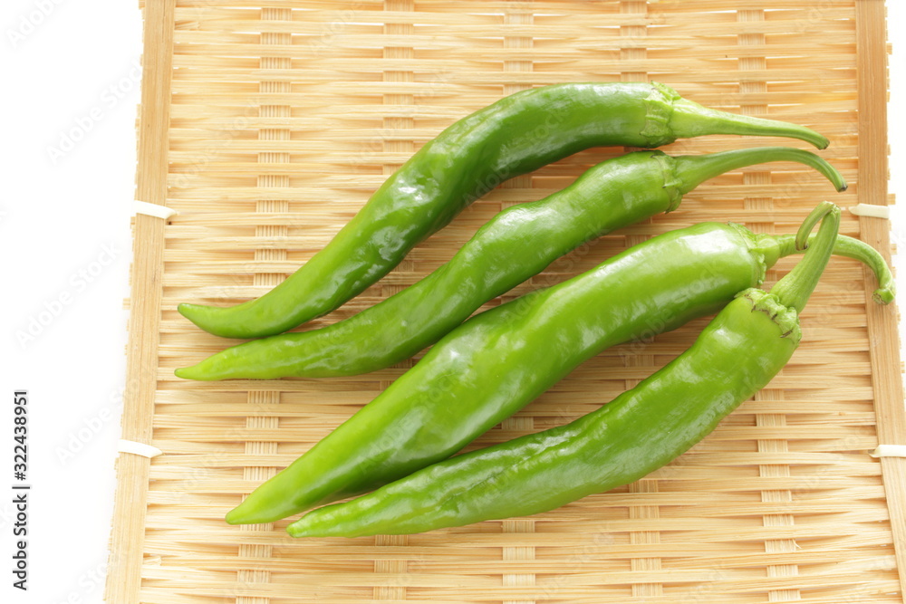 Japanese green pepper on bamboo basket for cooking image Japanese green pepper on bamboo basket for cooking image