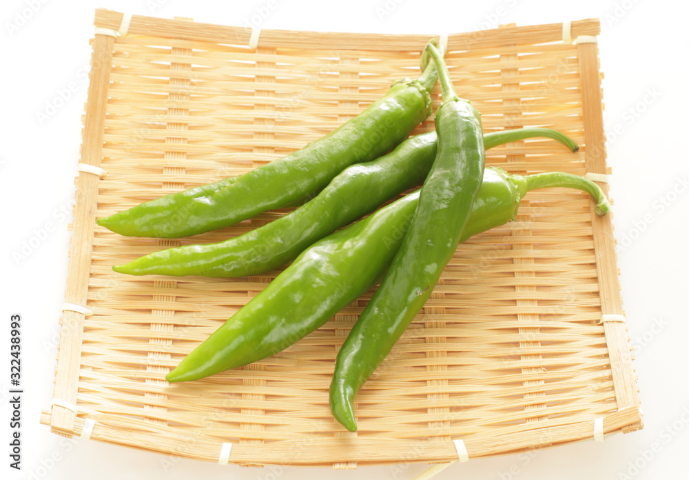 Japanese green pepper on bamboo basket for cooking image Japanese green pepper on bamboo basket for cooking image