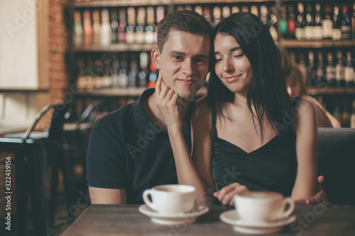 Loving couple hugging in the cafe.