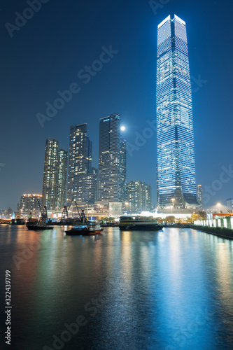 Skyscraper in Victoria harbor of Hong Kong city at night