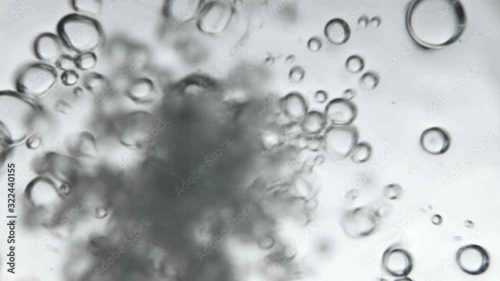 Air bubbles in the water while pouring water in glass, Photos from the underwater corner. Creative abstract background, Silver tone style. Air bubbles in the water while pouring water in glass, Photos from the underwater corner. Creative abstract background, Silver tone style.