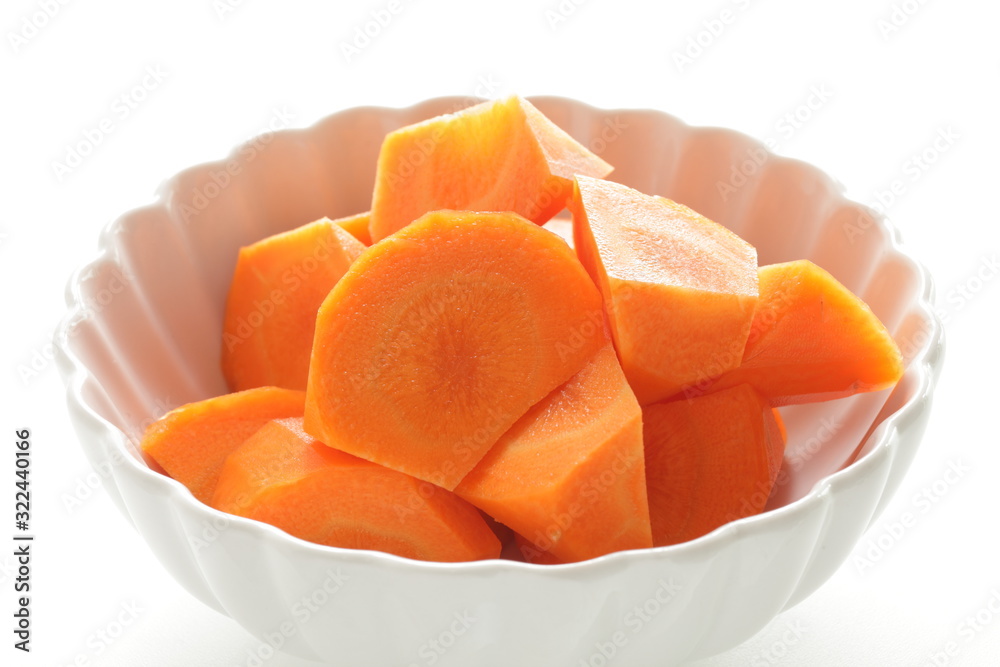 Chopped carrot in white bowl with copy space 