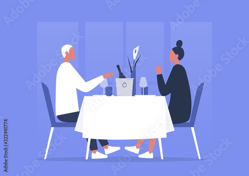 Fine dining restaurant, a couple of young adults having romantic dinner, anniversary celebration, first date or saint valentines day