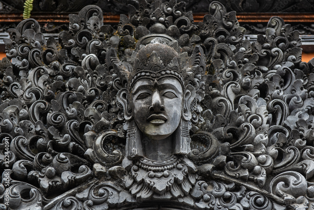 The traditional Balinese stone statue decorated in Pura Taman Ayun the royal temple of Mengwi empire in Badung Regency, Bali, Indonesia.