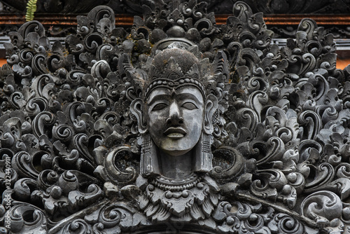 The traditional Balinese stone statue decorated in Pura Taman Ayun the royal temple of Mengwi empire in Badung Regency, Bali, Indonesia.
