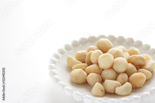 Roasted macadamia nuts on dish with copy space