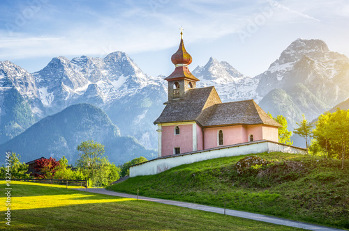 Scenic panoramic view of idyllic Auer Kircherl, an old historical chapel in the alps near the famous old village of Lofer, in beautiful golden evening light at sunset in summer, Salzburg Land, Austria