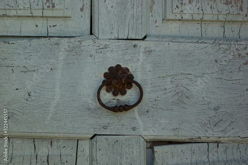 old wooden farmhouse door with unique metal handle