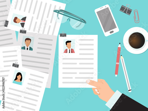 Recruitment with cv view from the top concept. HR manager looks through resumes of employees. Business man looking for company employee by curriculum vitae. Hand with cv on the top of desk.