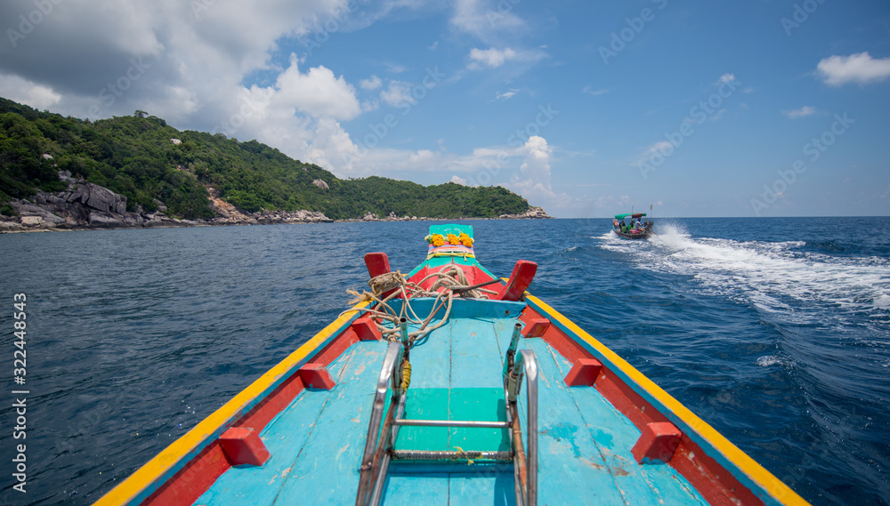 Traditional wooden boat in a picture perfect tropical Sky with clouds and ocean at koh tao island,Thailand ,Asia